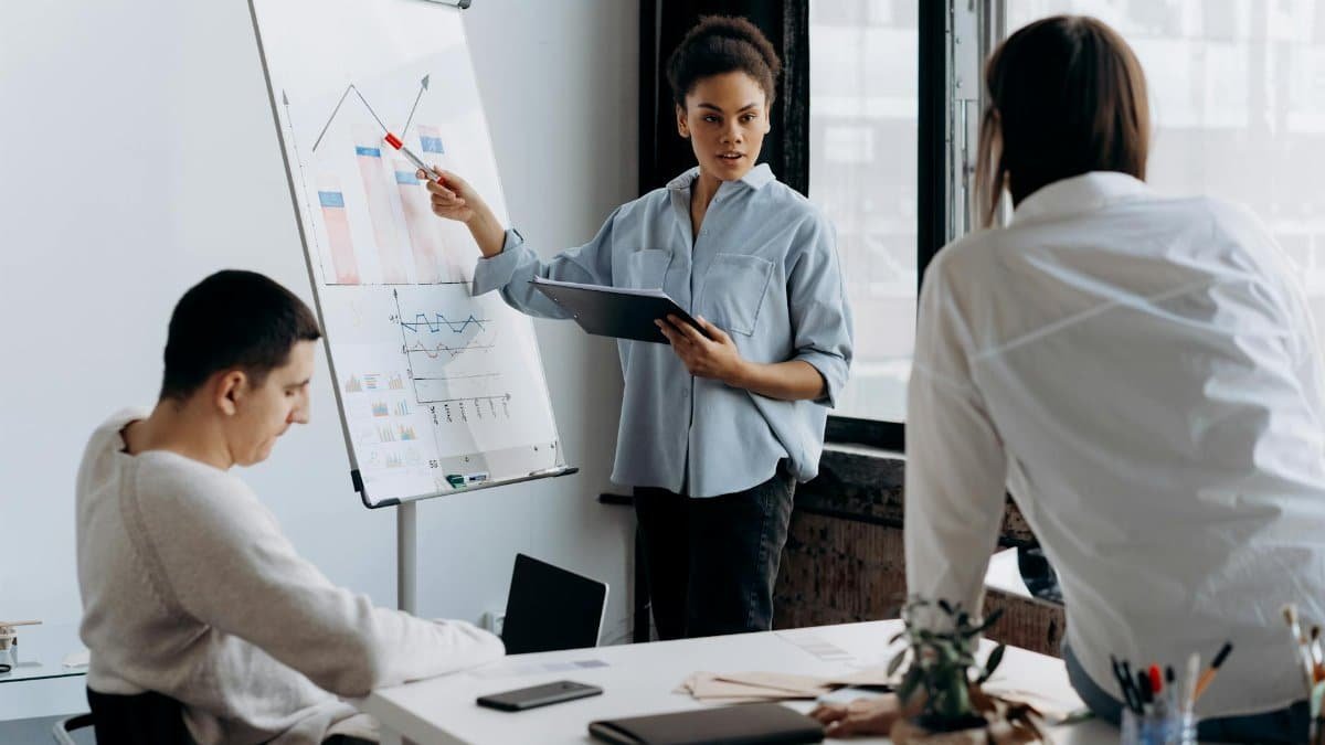 Business team discussing strategy with a presentation in a modern office setting.