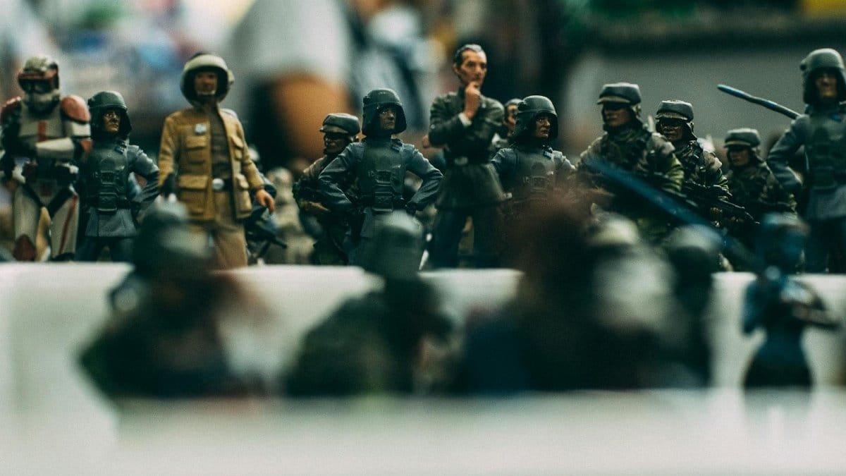 Detailed close-up of miniature toy soldiers arranged in a battle formation, showcasing military uniforms and weapons.