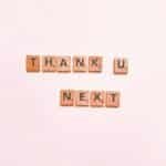 Scrabble tiles display 'Thank U Next' on a clean white background, perfect for creative projects.