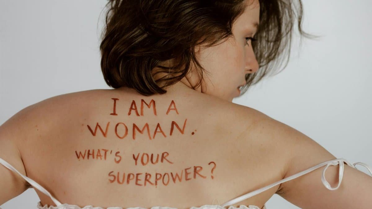 Back view of woman with empowering message, promoting self-love and feminism.