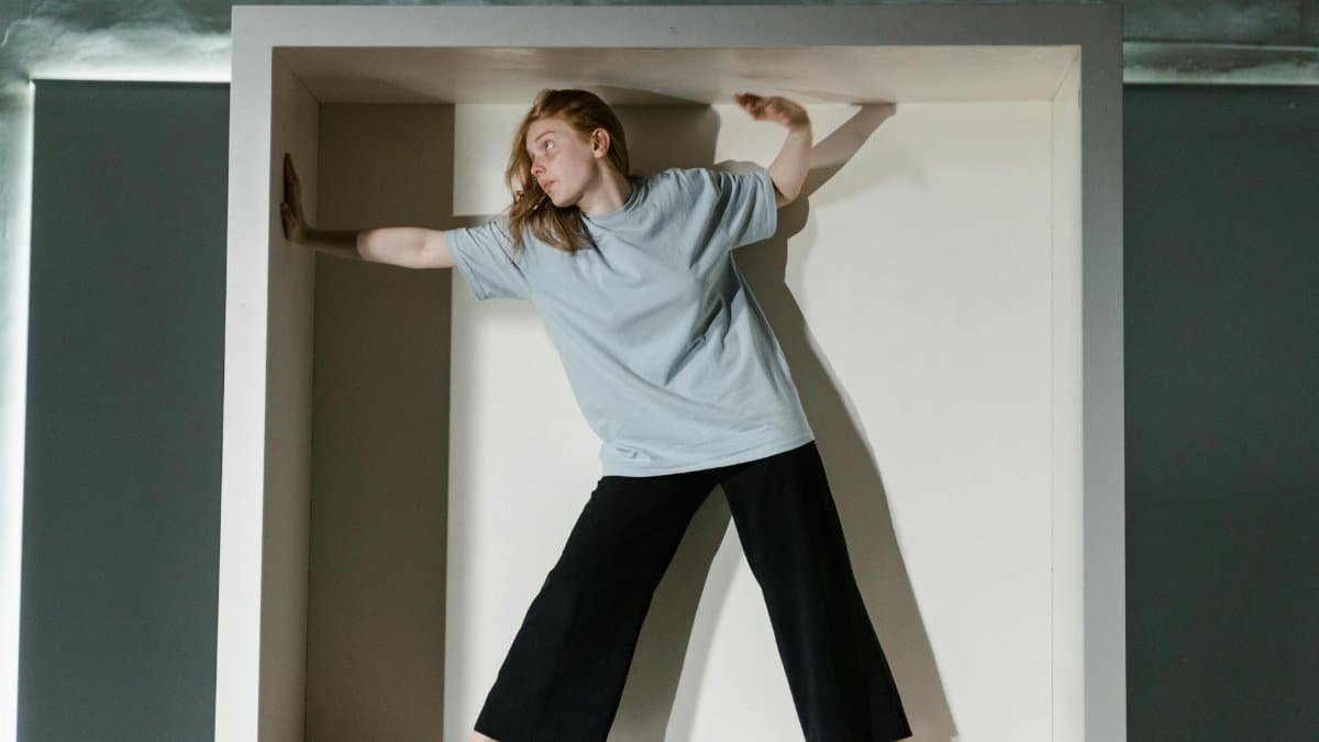 A woman trapped in a small box symbolizing claustrophobia and anxiety.