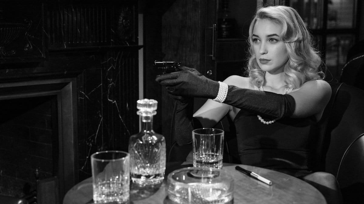 Elegant femme fatale holding a handgun, creating a vintage noir atmosphere indoors.