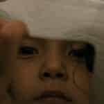 Close-up of a child gazing at their reflection in a mirror in Gigante, Huila, Colombia.
