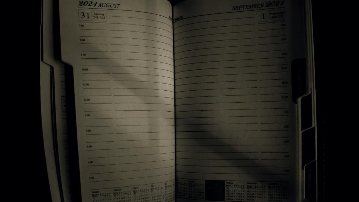 An open planner showing the transition from August to September 2021, symbolizing time management.