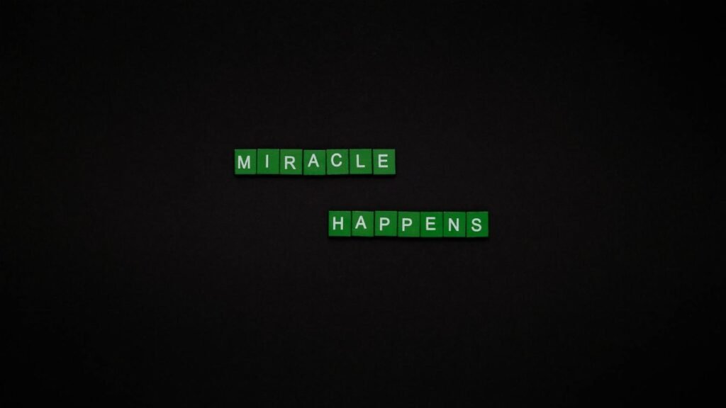 Motivational image featuring the words 'Miracle Happens' using green tiles on a black backdrop.