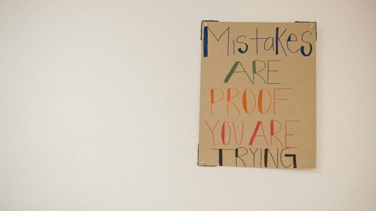 A motivational poster with the phrase 'Mistakes are proof you are trying.'