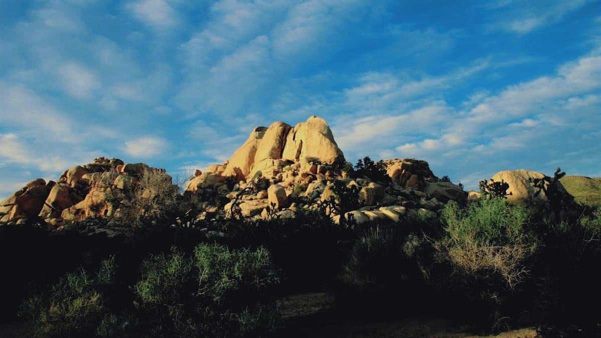 Dramatic view of desert rock formations against a vibrant sky.