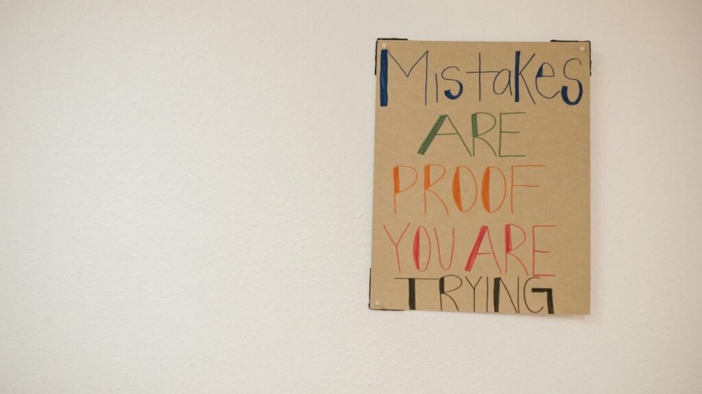 A motivational poster with the phrase 'Mistakes are proof you are trying.'