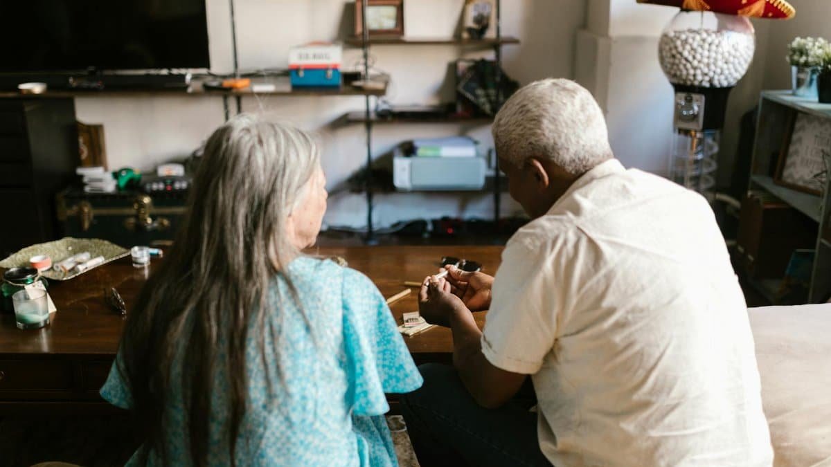 Elderly couple enjoying a relaxed moment indoors with cannabis products, showcasing a modern lifestyle.