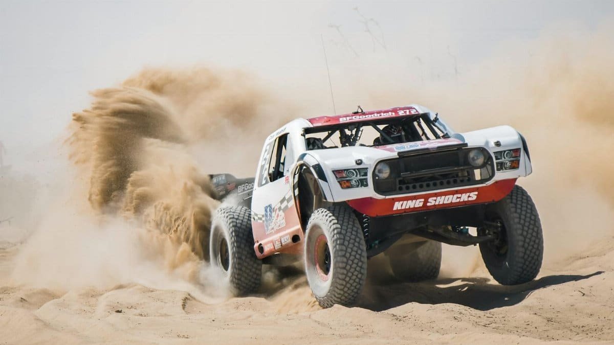 Dynamic shot of an offroad vehicle kicking up sand in a Mexico desert.