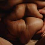 Intimate and close-up shot emphasizing body positivity and self-acceptance.