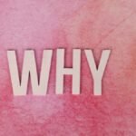 Bold white letters spelling WHY on a pink textured background for conceptual design.