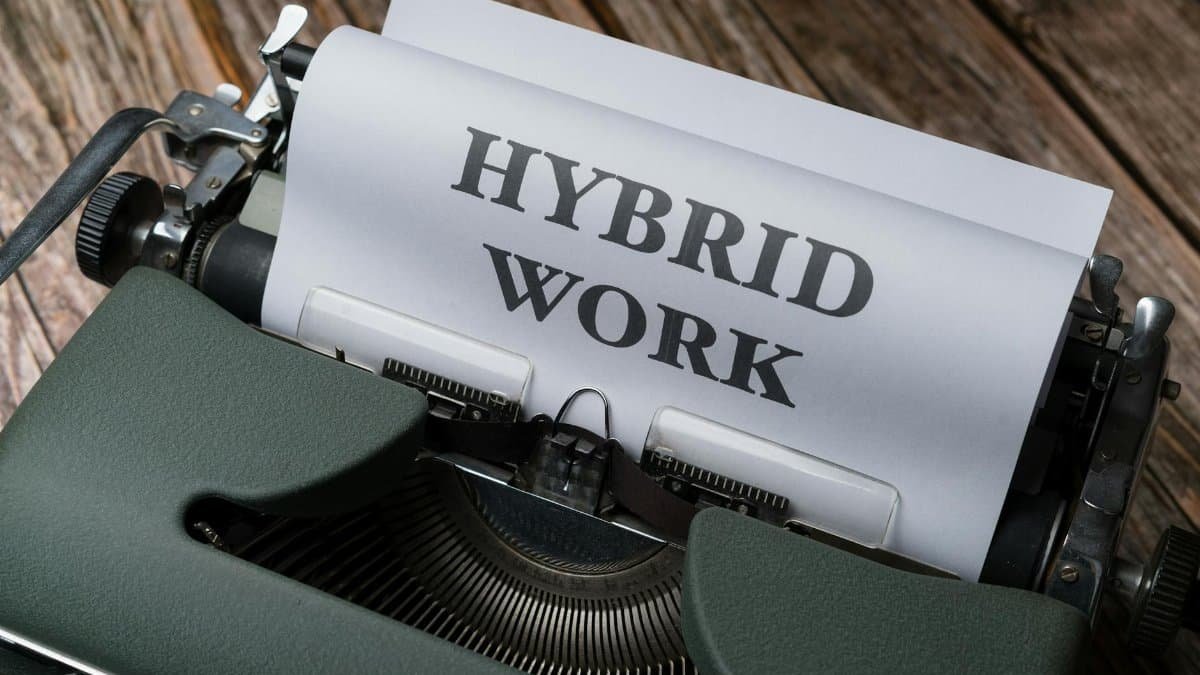 Retro typewriter with 'Hybrid Work' text, symbolizing modern work trends.