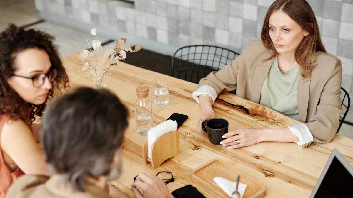Colleagues having a team discussion at a contemporary café.