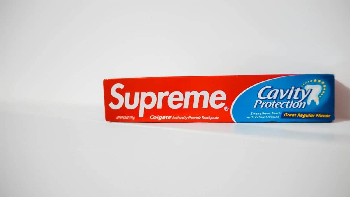 Red and blue toothpaste box with copy space on a white background.