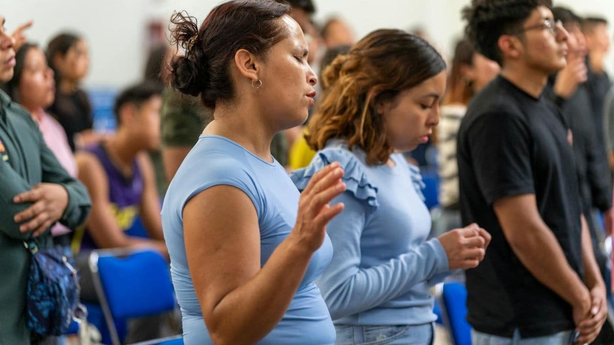 People engaged in a prayer session inside a church in Ciudad de México, expressing spirituality and community.