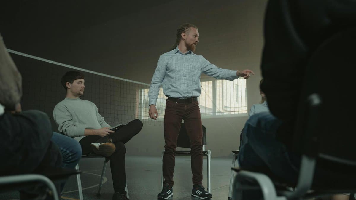 A group therapy session indoors with diverse adults engaging in discussion and support.