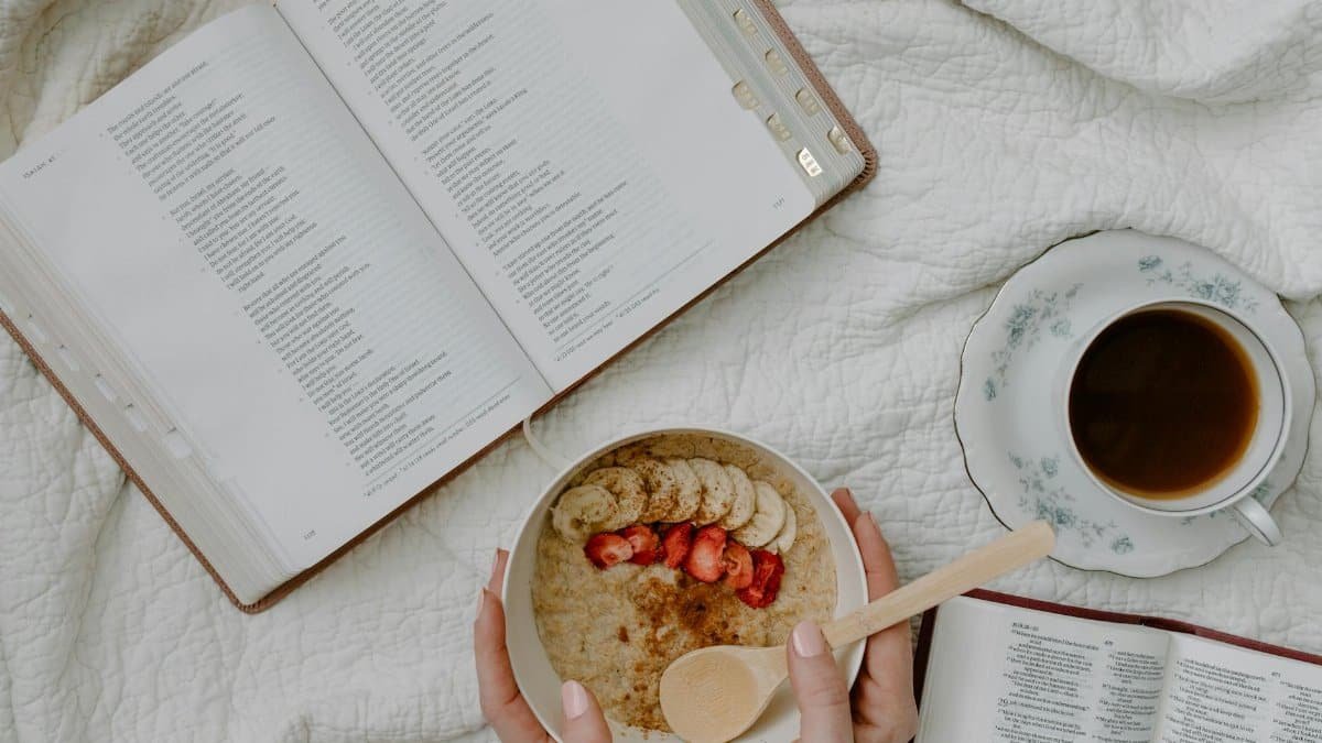 A serene morning setup with a Bible, coffee, and oatmeal for reflective study.