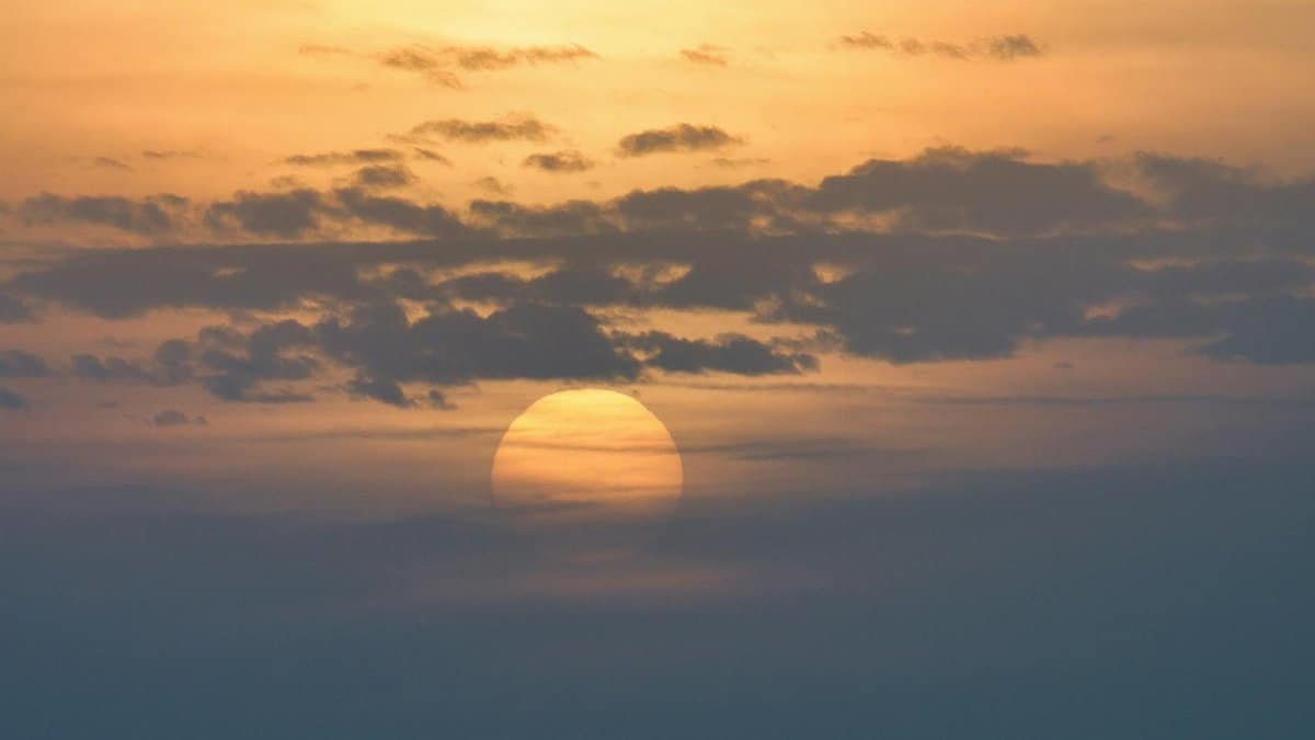 Beautiful sunrise over Poprad with sun partially hidden by clouds.