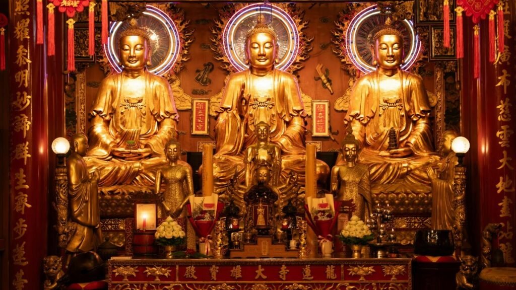 A stunning display of golden Buddha statues in a richly decorated temple. Intricate details enhance the sacred atmosphere.