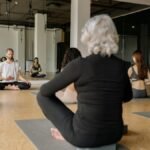 A diverse group practicing yoga in a modern, serene studio space promoting wellness.