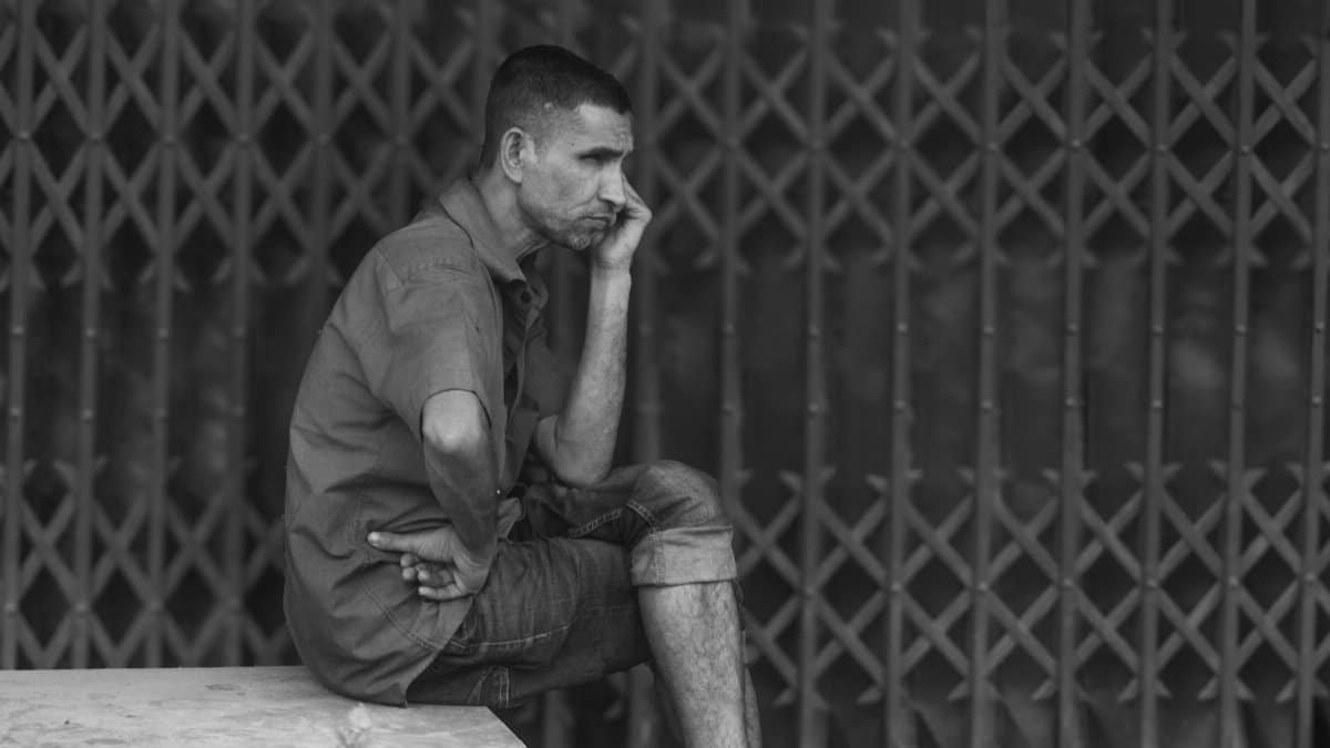 A thoughtful portrait of a man in Bangladesh, highlighting resilience and contemplation.