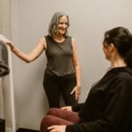Two women exercising with gym equipment, promoting fitness and wellness indoors.