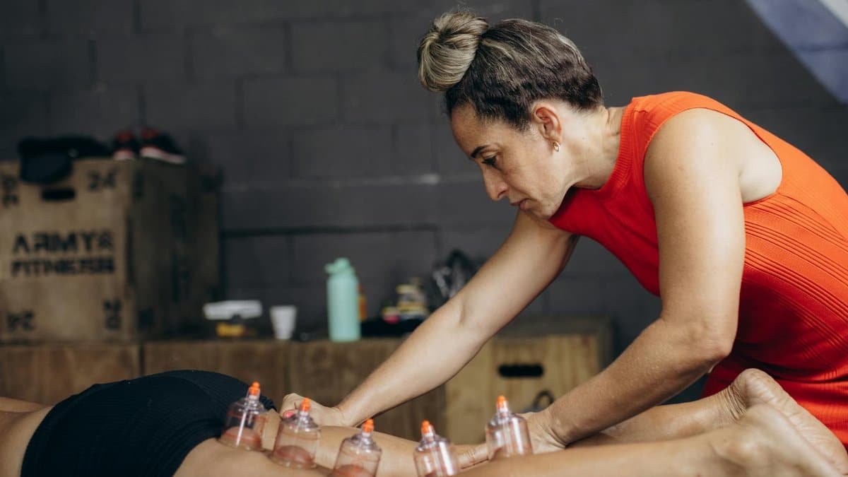 A therapist uses cupping therapy to enhance muscle recovery and flexibility.