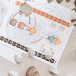 A serene setup of spiritual diagrams and crystals on a beige surface, symbolizing holistic healing and balance.