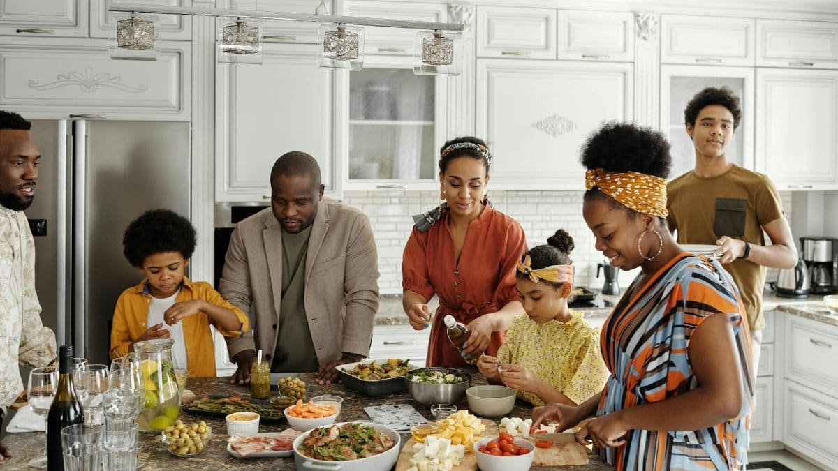 A happy family gathers in the kitchen to prepare a delicious meal together, fostering togetherness and joy.