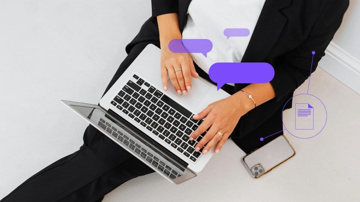 High-angle shot of a woman in black suit using a laptop, symbolizing digital communication.