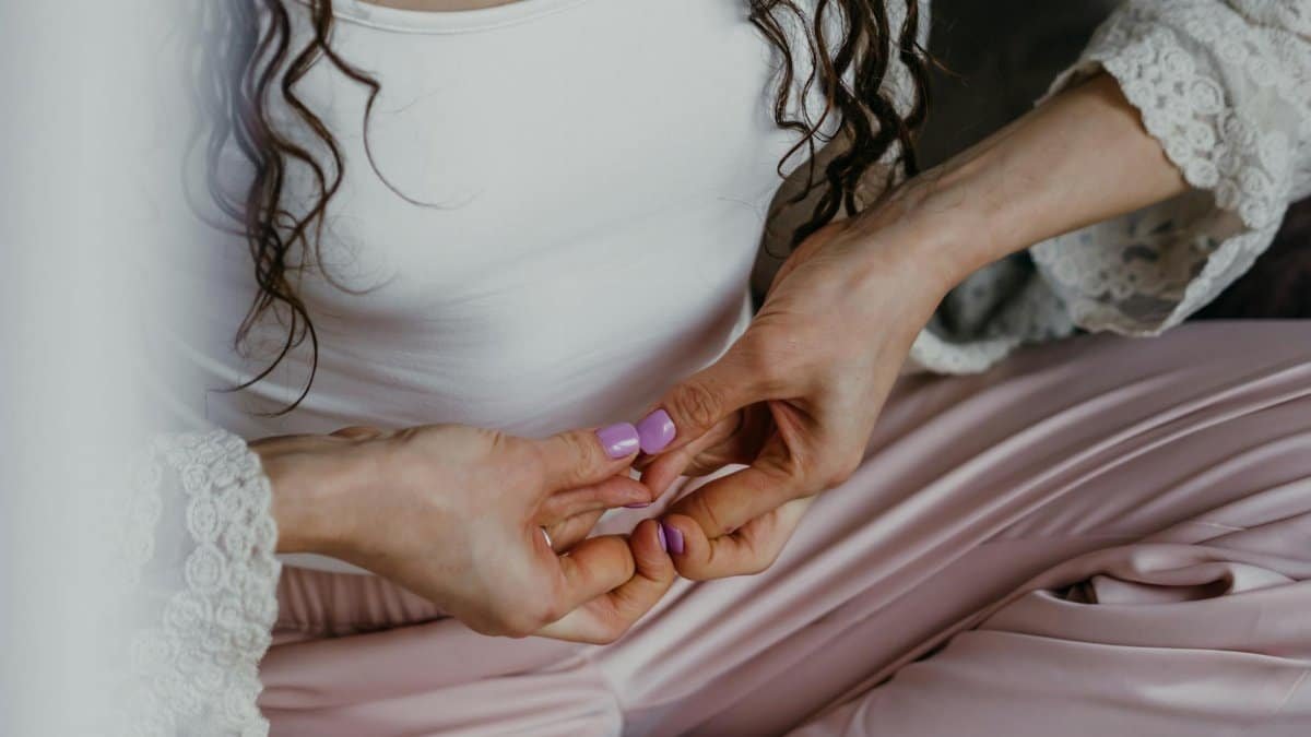 Close-up of hands in yoga mudra. Promotes relaxation and mindfulness.