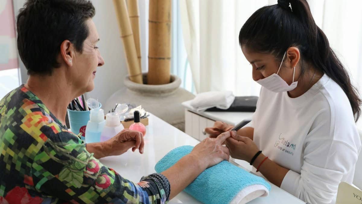 Woman enjoying a relaxing manicure in a peaceful salon setting.
