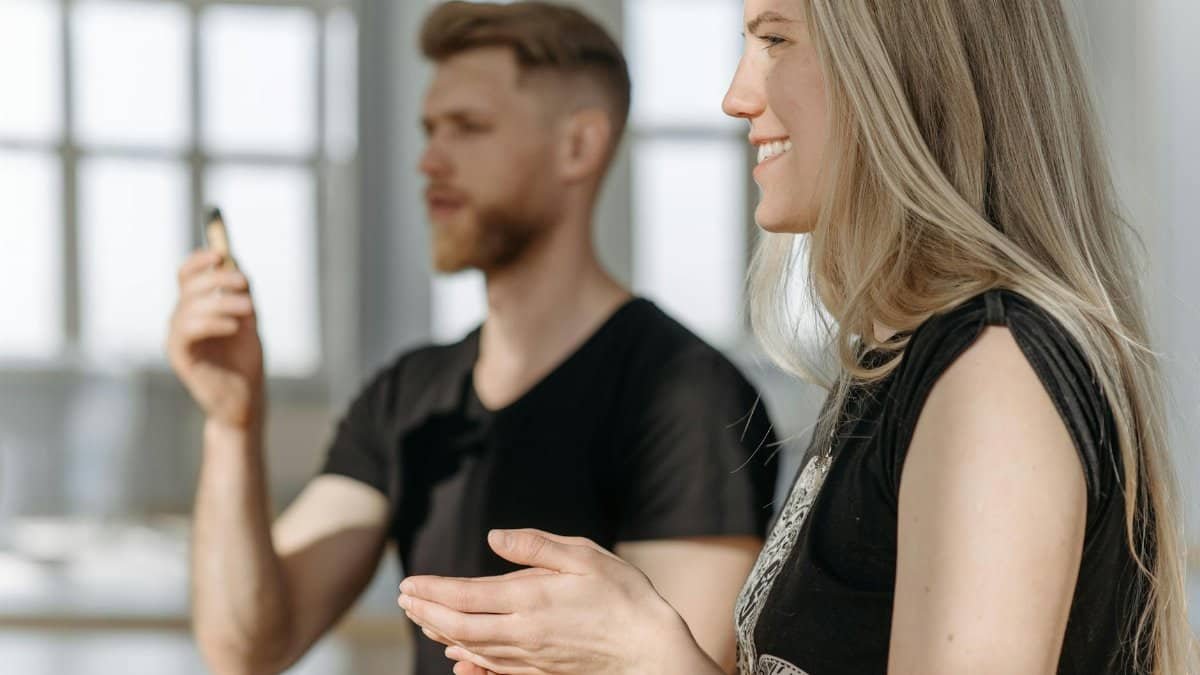 Two adults practicing meditation indoors with natural light and focus on mindfulness.