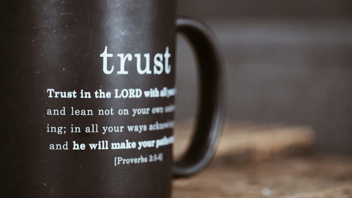 Black mug featuring the Bible verse from Proverbs 3:5-6 about trust and faith.