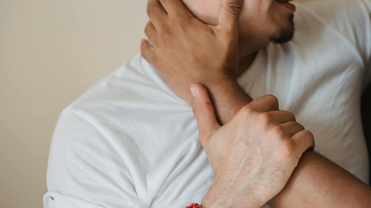 Close-up of a couple embracing intimately, focusing on hands and facial expression.