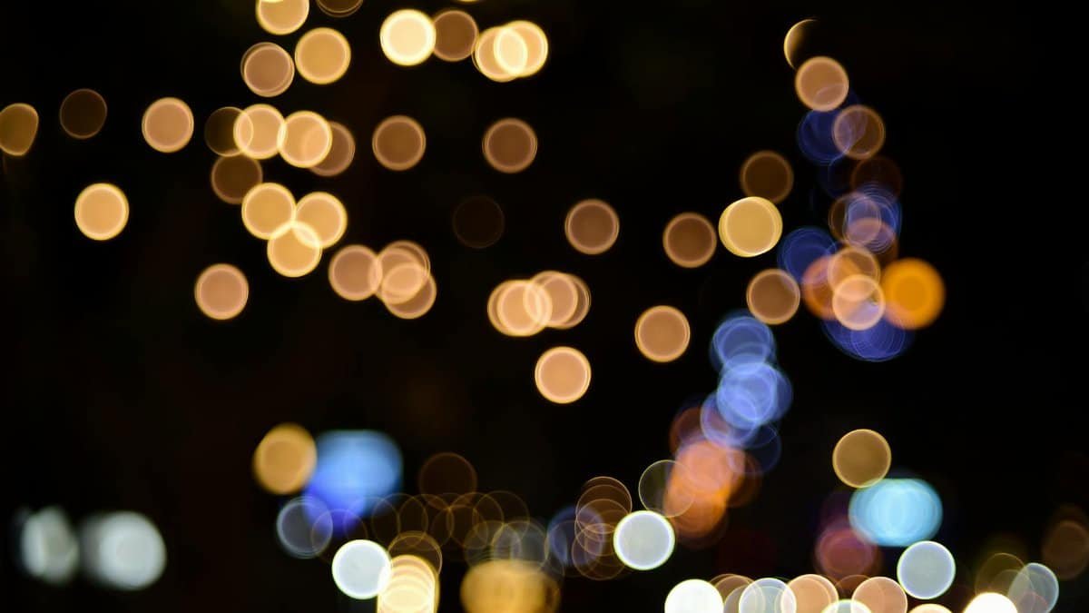 Colorful bokeh pattern of city lights creating an abstract artistic background.