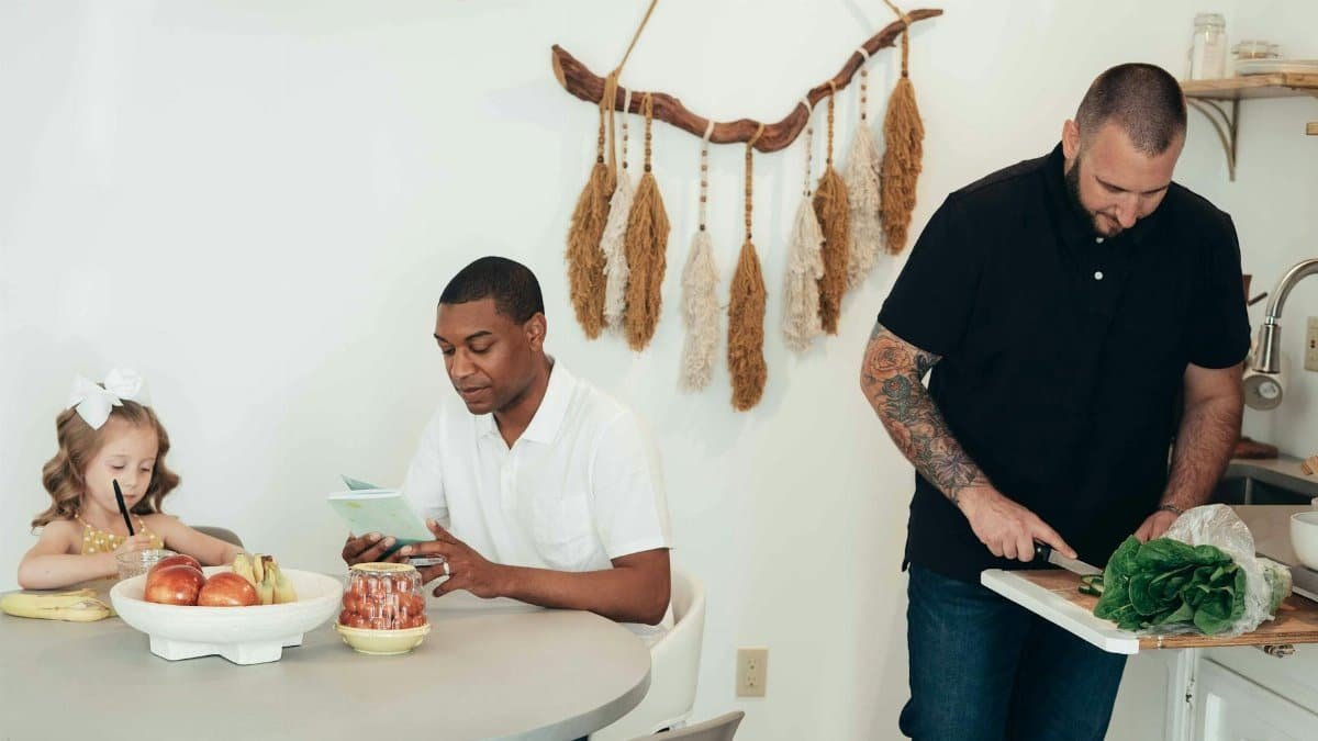 A diverse family sharing a meal in a modern kitchen setting, promoting family bonding.