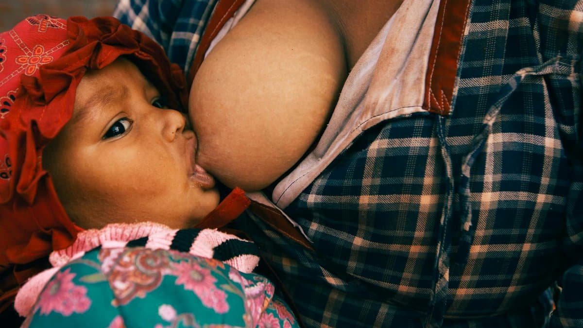 Close-up of a mother breastfeeding her baby, showcasing motherhood and bonding.