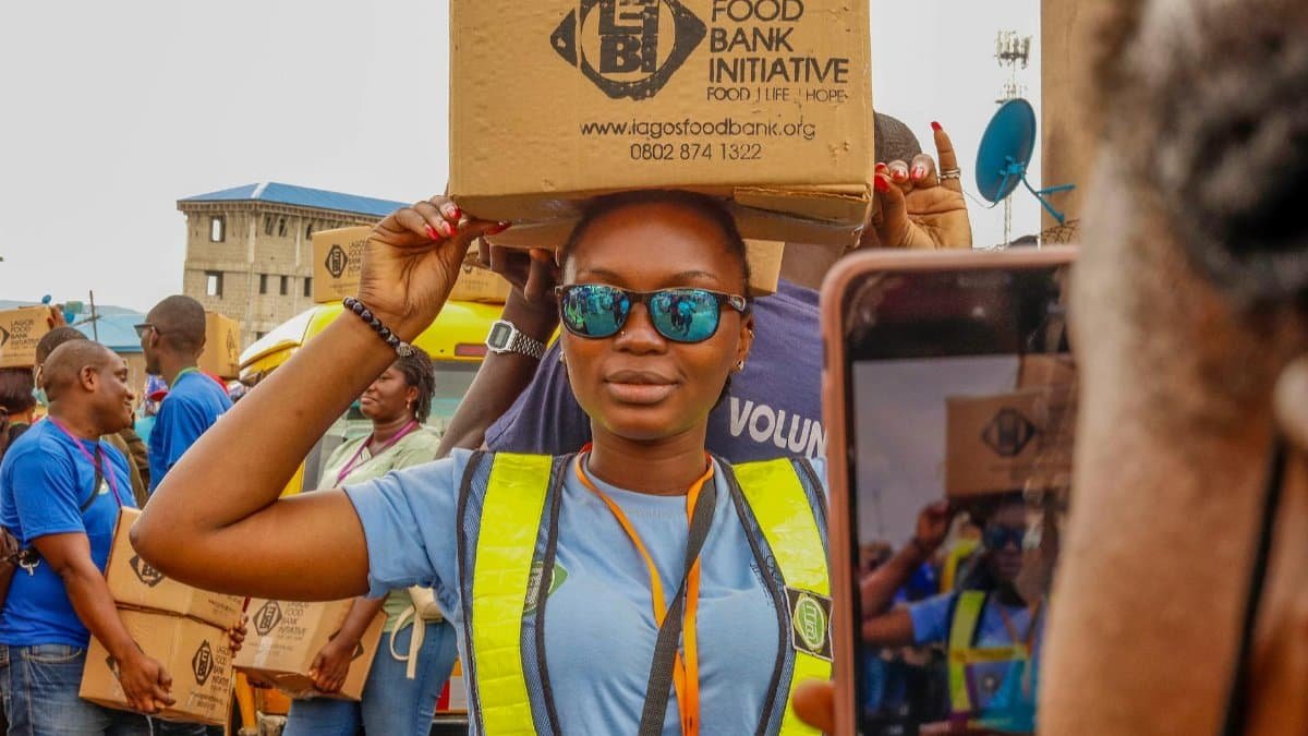 Volunteers distribute food boxes at the Lagos Food Bank Initiative, supporting local communities.
