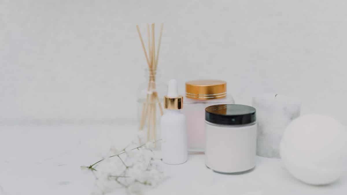 Elegant minimalistic display of skincare products and aromatherapy essentials on a clean white background.