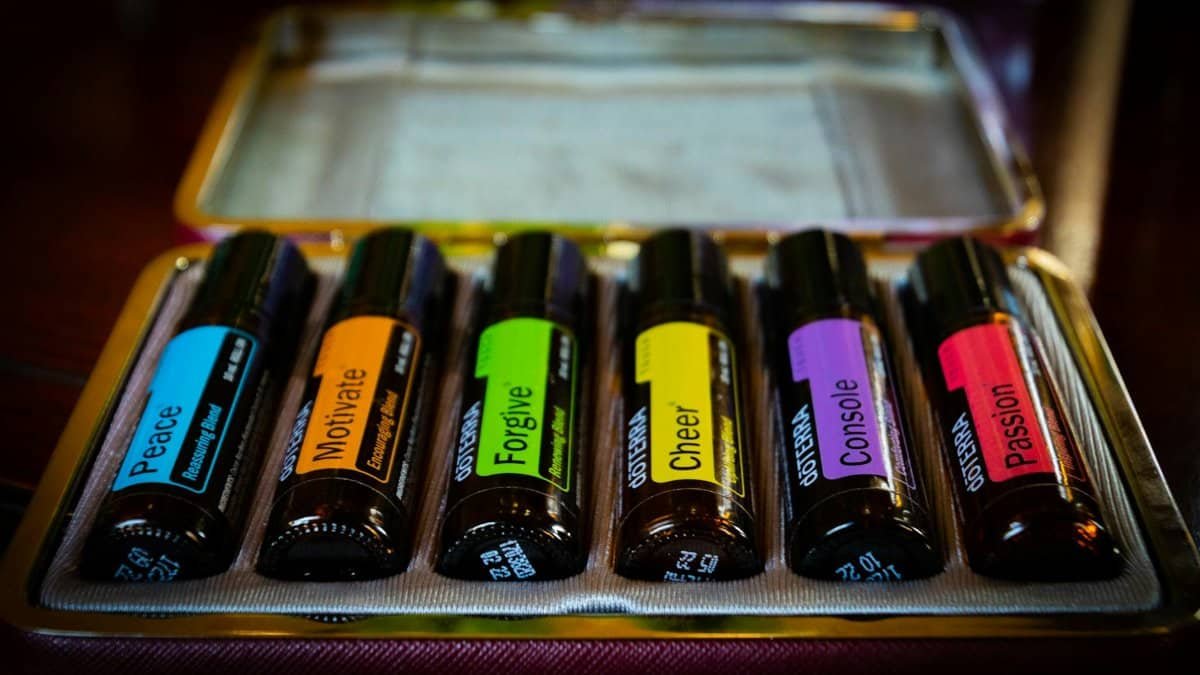 Colorful essential oil bottles in a case, each labeled with emotional themes. Perfect for aromatherapy enthusiasts.