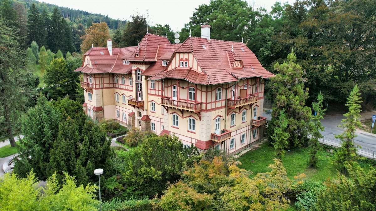 Beautiful aerial view of an historic villa surrounded by lush greenery in Luhačovice, Czechia.