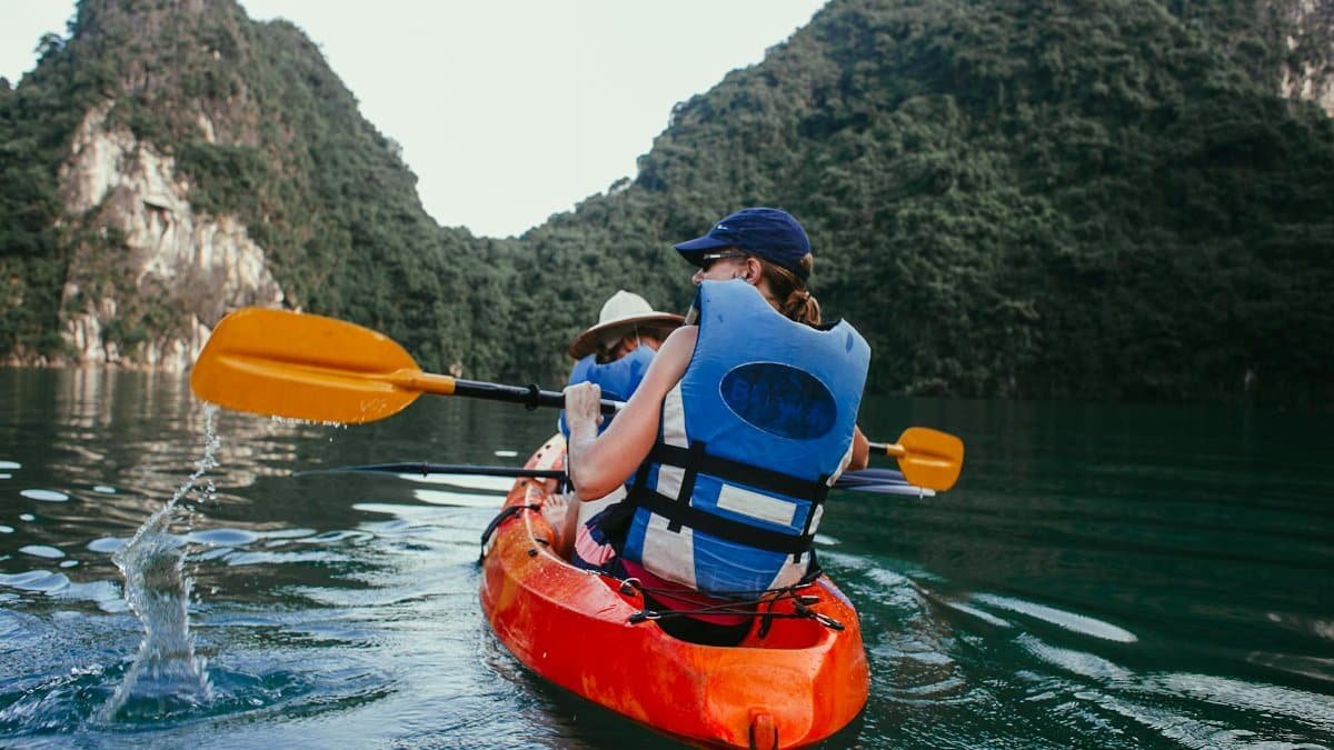 Enjoy a thrilling kayaking experience in stunning coastal waters surrounded by lush mountains.