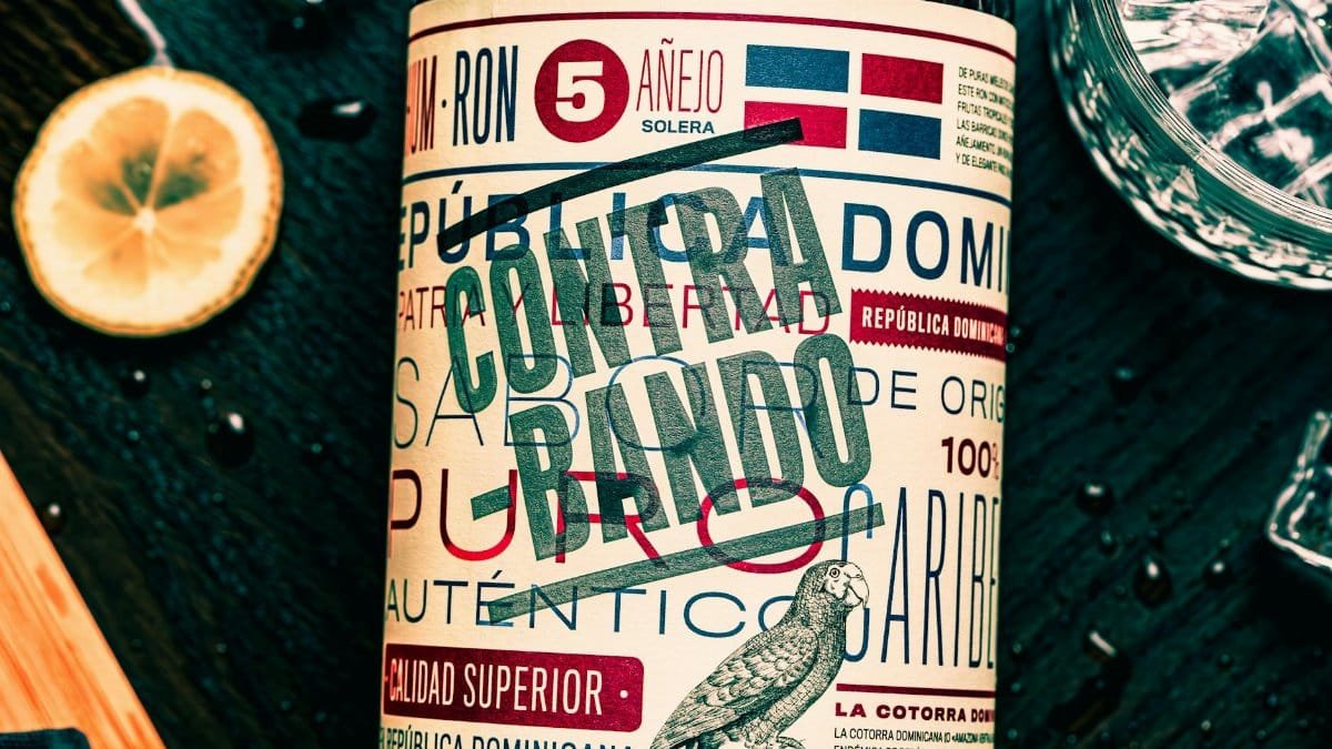 Close-up of a Dominican rum bottle featuring a vibrant Contrabando label with glass and lemon slice.