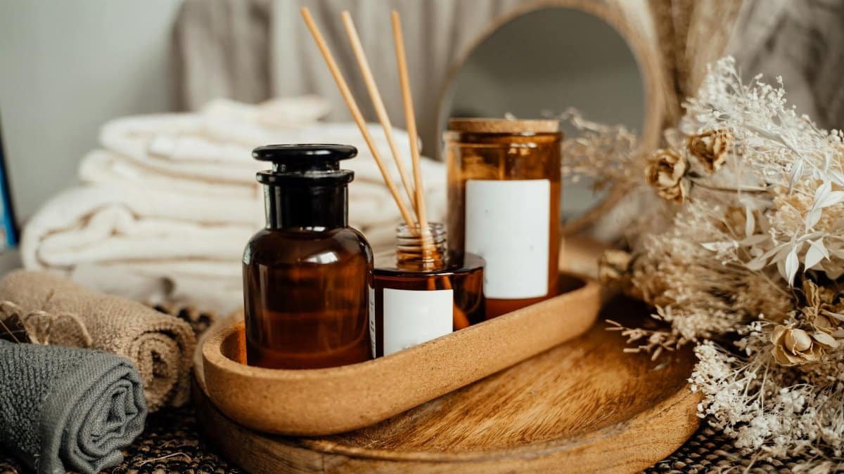 A tranquil spa setup featuring aromatherapy oils, candles, and dried flowers for relaxation.