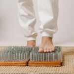 Foot close-up on a sadhu board for alternative healing and wellness practice.