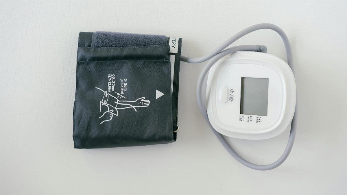 A digital sphygmomanometer on a white background, used for measuring blood pressure.
