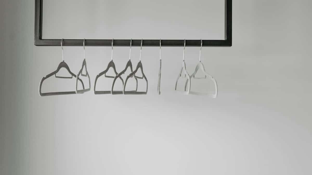 A minimalist display of empty clothes hangers on a rack, ideal for fashion themes.