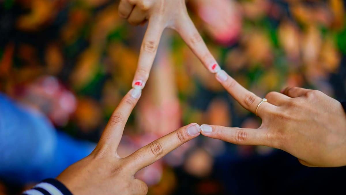 Close-up of hands forming a star shape, symbolizing unity and friendship.